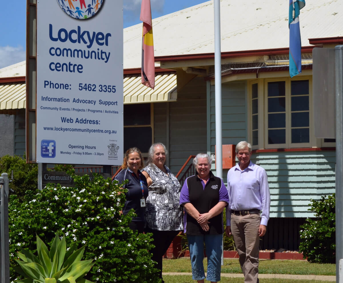 Four people standing outside building